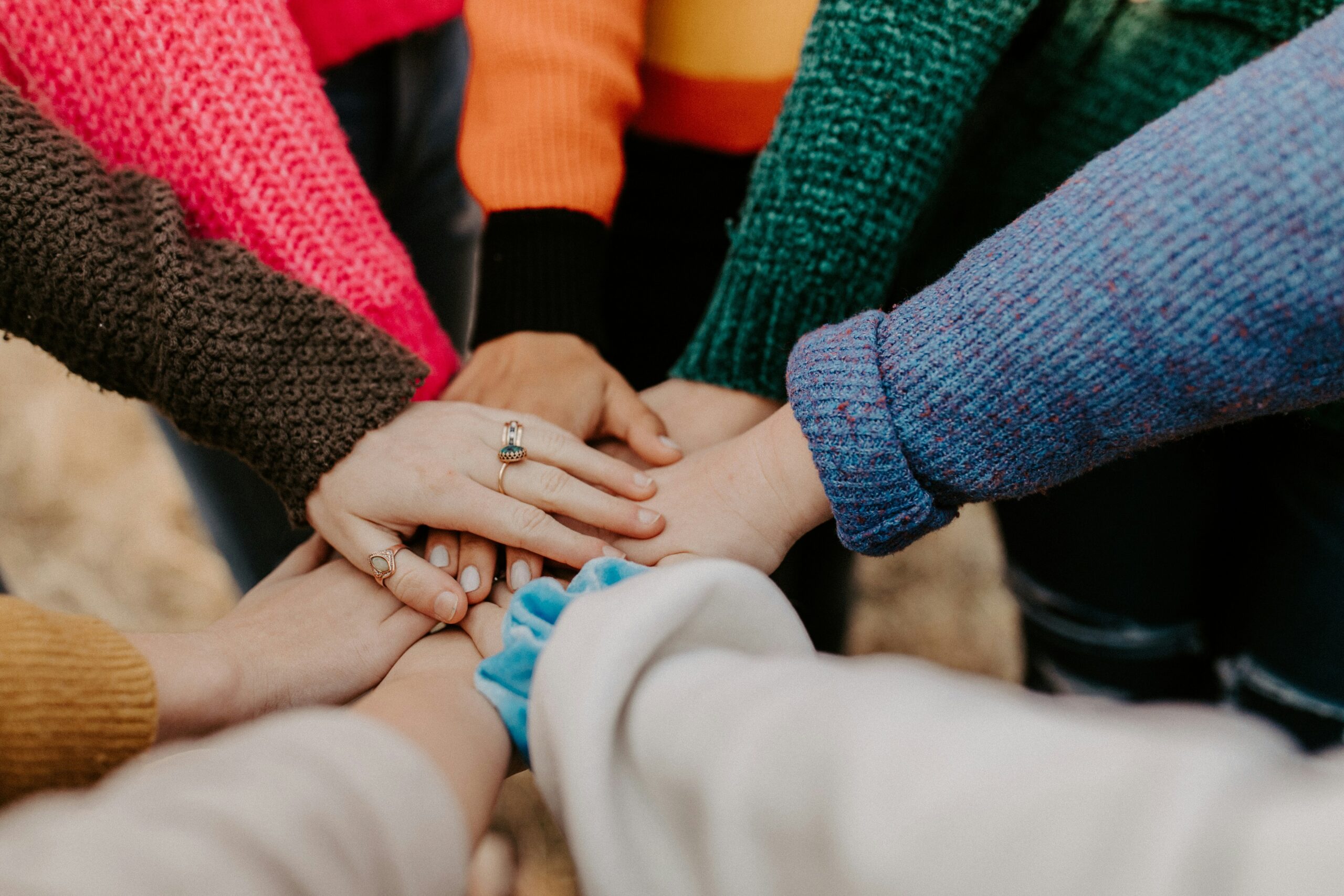 womens hands stacked on top of each other